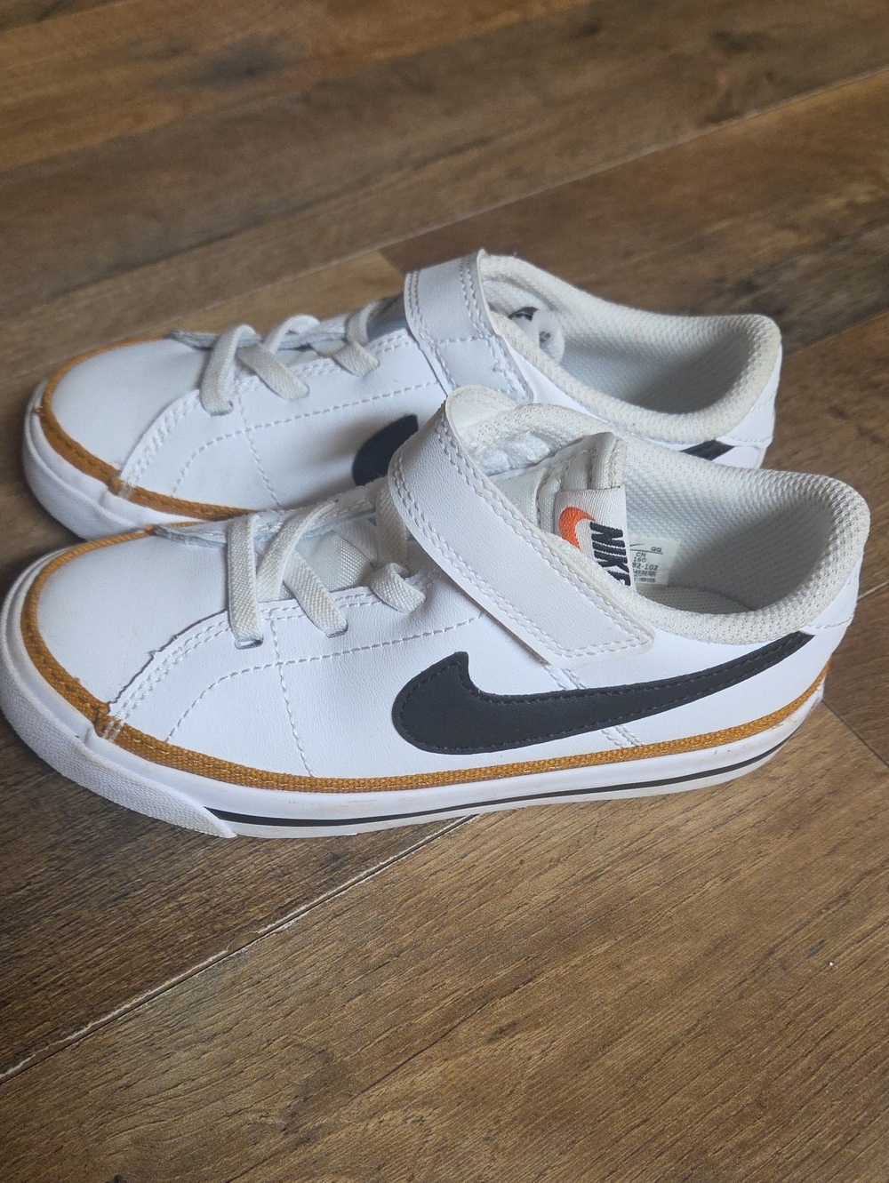 Nike Kids White Sneakers with Black Swoosh and Tan Trim